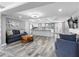 Open concept living room with a modern kitchen, stylish decor, and hardwood flooring at 5425 Bluepoint Dr, Port Richey, FL 34668
