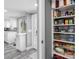 Organized pantry featuring white cabinets, shelving, and easy access to the kitchen at 5425 Bluepoint Dr, Port Richey, FL 34668