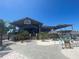 Inviting waterfront restaurant featuring outdoor seating, palm trees, and a relaxed vibe at 5425 Bluepoint Dr, Port Richey, FL 34668