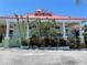 Charming exterior of Catches Restaurant with vibrant landscaping, a red roof, and ample parking at 5425 Bluepoint Dr, Port Richey, FL 34668