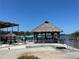 Picturesque waterfront tiki bar with thatched roof, outdoor seating and waterfront views at 5425 Bluepoint Dr, Port Richey, FL 34668