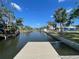 Backyard view leading to a private dock on the serene waterfront, ideal for relaxation and boating at 5425 Bluepoint Dr, Port Richey, FL 34668