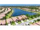 Beautiful aerial view of lakeside homes with well-manicured lawns, landscaping, and tile roofs at 5728 Sunset Falls Dr, Apollo Beach, FL 33572