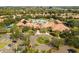 Gorgeous aerial view of the community clubhouse and pool area, surrounded by lush landscaping at 5728 Sunset Falls Dr, Apollo Beach, FL 33572