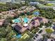 Beautiful aerial view of a community pool area with a clubhouse, lounge chairs, and lush landscaping at 5728 Sunset Falls Dr, Apollo Beach, FL 33572