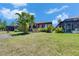 Well-maintained backyard with screened-in patio and view of neighboring houses and green lawn at 5728 Sunset Falls Dr, Apollo Beach, FL 33572