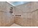 Bathroom shower showcasing neutral tile, with a handrail, and caddy at 5728 Sunset Falls Dr, Apollo Beach, FL 33572