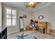 Cozy bedroom with a ceiling fan, plantation shutters, starfish rug, and wood-look flooring at 5728 Sunset Falls Dr, Apollo Beach, FL 33572