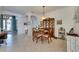 Traditional dining room with a round table, china cabinet, and seamless access to other living spaces at 5728 Sunset Falls Dr, Apollo Beach, FL 33572