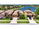 Beautiful waterfront single-Gathering home featuring lush landscaping and a tile roof at 5728 Sunset Falls Dr, Apollo Beach, FL 33572