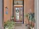 Welcoming front entrance with decorative plants, a wreath, and a tile floor at 5728 Sunset Falls Dr, Apollo Beach, FL 33572