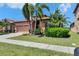 Charming single-story home featuring a tile roof, two-car garage, and lush landscaping at 5728 Sunset Falls Dr, Apollo Beach, FL 33572