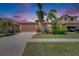 Charming single-story home featuring a tile roof, two-car garage, and lush landscaping at 5728 Sunset Falls Dr, Apollo Beach, FL 33572