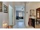 Hallway view leading to an office space with natural light and modern décor at 5728 Sunset Falls Dr, Apollo Beach, FL 33572