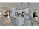 Kitchen with bar seating, tile floors and adjacent dining area at 5728 Sunset Falls Dr, Apollo Beach, FL 33572