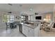 Open-concept kitchen with a center island, granite countertops, and views of the adjacent living areas at 5728 Sunset Falls Dr, Apollo Beach, FL 33572