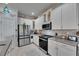 Bright kitchen with white cabinets, stainless steel appliances, and granite countertops at 5728 Sunset Falls Dr, Apollo Beach, FL 33572