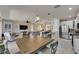 Open-concept kitchen with stainless steel appliances, granite countertops, and an adjacent dining area at 5728 Sunset Falls Dr, Apollo Beach, FL 33572