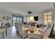 Inviting living room with tile floors, plush seating, and sliding glass doors to the lanai at 5728 Sunset Falls Dr, Apollo Beach, FL 33572