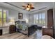 Calm main bedroom with wood grain floors, a fan, and lots of natural light from a window at 5728 Sunset Falls Dr, Apollo Beach, FL 33572