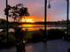 A mesmerizing lake view at sunset with colorful hues across the sky, seen from the screened patio at 5728 Sunset Falls Dr, Apollo Beach, FL 33572