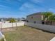 Large backyard featuring a fire pit, string lights, and privacy fence, offering a great space for entertaining at 6222 Trent Creek Dr, Sun City Center, FL 33573