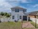 Backyard view showcasing a brick patio with fire pit and a white fence for privacy at 6222 Trent Creek Dr, Sun City Center, FL 33573