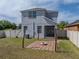 View of the backyard showing a brick patio, firepit, string lights, and a white fence at 6222 Trent Creek Dr, Sun City Center, FL 33573
