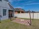 Spacious backyard with a fire pit area, string lights, and a privacy fence, ideal for outdoor entertainment at 6222 Trent Creek Dr, Sun City Center, FL 33573