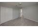 Neutral bedroom showcases gray walls, carpet, closet with folding doors, and a hallway view at 6222 Trent Creek Dr, Sun City Center, FL 33573