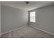 Cozy bedroom with soft gray walls and carpet featuring a window with coverings at 6222 Trent Creek Dr, Sun City Center, FL 33573