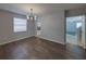 Dining area with modern light fixture and seamless flow to kitchen, showcasing hardwood floors at 6222 Trent Creek Dr, Sun City Center, FL 33573