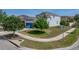Picture of a two-story home with trees, grass, blue garage door, and a real estate sign at 6222 Trent Creek Dr, Sun City Center, FL 33573