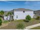 Two-story home featuring a stucco exterior, well-maintained lawn, and tasteful landscaping creating a welcoming curb appeal at 6222 Trent Creek Dr, Sun City Center, FL 33573
