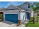Charming two-story home featuring a bright blue garage door, stone accents, and well-manicured lawn at 6222 Trent Creek Dr, Sun City Center, FL 33573