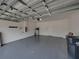 Spacious two-car garage featuring a light grey painted floor at 6222 Trent Creek Dr, Sun City Center, FL 33573