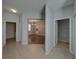 Spacious hallway featuring tile flooring with views into the living room, bathroom and laundry at 6222 Trent Creek Dr, Sun City Center, FL 33573