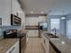 Bright kitchen featuring stainless steel appliances, granite countertops, and white cabinetry at 6222 Trent Creek Dr, Sun City Center, FL 33573