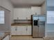 Kitchen showcases modern stainless steel refrigerator and ample white cabinet space at 6222 Trent Creek Dr, Sun City Center, FL 33573