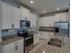 Kitchen features granite countertops, stainless steel appliances, and ample white cabinet space at 6222 Trent Creek Dr, Sun City Center, FL 33573
