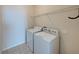 Functional laundry area equipped with modern appliances and convenient overhead storage at 6222 Trent Creek Dr, Sun City Center, FL 33573