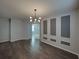Elegant living room featuring modern lighting, decorative wall panels, and stylish wood flooring at 6222 Trent Creek Dr, Sun City Center, FL 33573