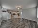 Spacious living room with hardwood floors adjacent to the bright kitchen and carpeted stairs at 6222 Trent Creek Dr, Sun City Center, FL 33573