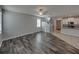 Open living room with hardwood floors, a ceiling fan, and natural light at 6222 Trent Creek Dr, Sun City Center, FL 33573
