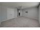 Main bedroom with neutral carpet, ceiling fan, TV mount, and an en-suite bathroom at 6222 Trent Creek Dr, Sun City Center, FL 33573