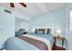 Comfortable bedroom with light blue walls, a ceiling fan, and a mirrored closet at 6279 Sun Blvd # 103, St Petersburg, FL 33715