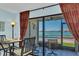 Inviting dining area with water view, tile flooring, and direct access to the patio at 6279 Sun Blvd # 103, St Petersburg, FL 33715