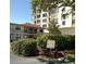 Casa V Condo main entrance showcases lush landscaping and a welcoming sign for residents and guests at 6279 Sun Blvd # 103, St Petersburg, FL 33715