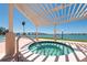 Relax in the community hot tub with a covered pergola, offering views of the ocean and bridge at 6279 Sun Blvd # 103, St Petersburg, FL 33715