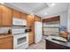 Bright kitchen with white appliances, granite countertops, and ample cabinet space at 6279 Sun Blvd # 103, St Petersburg, FL 33715